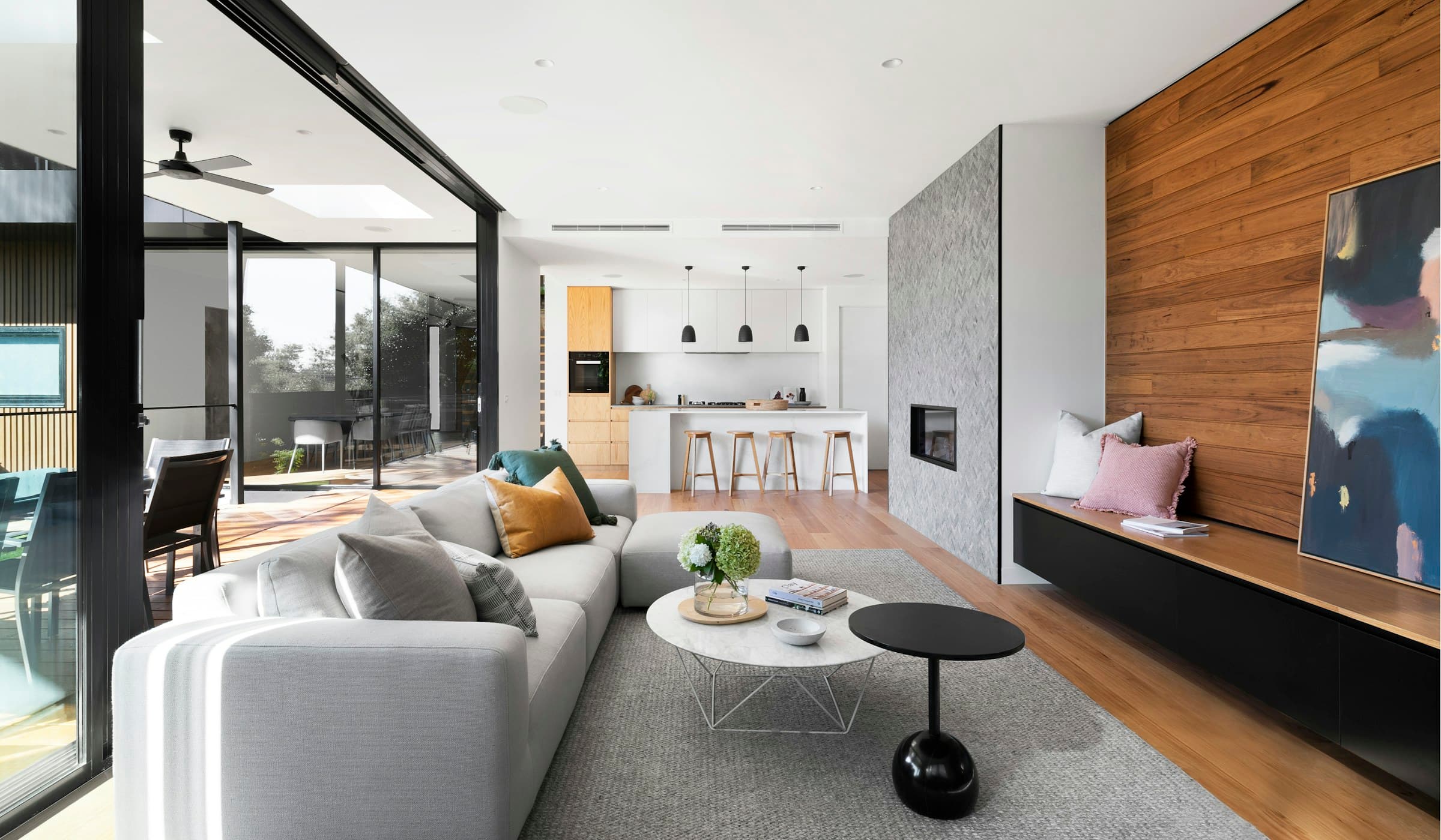A quiet double-height living room washed with evening light